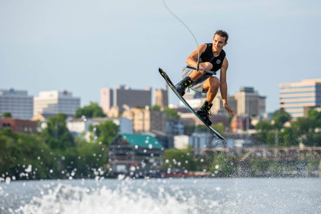 A student leaps out of the Tennessee River on a wakeboard