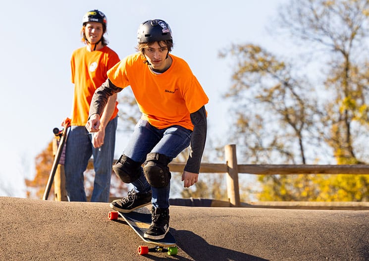 A skateboarder drops in at a local skate park