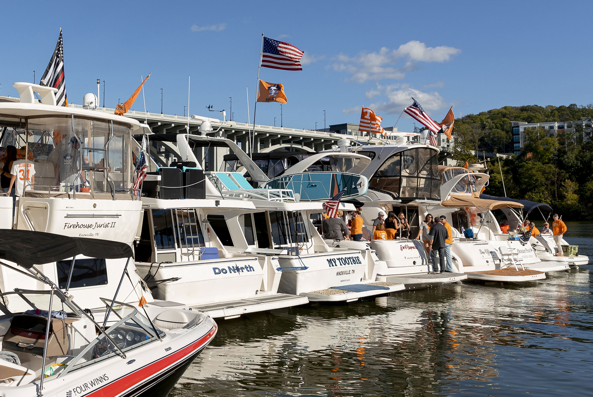Large boats flying UT flags line the marina on game day