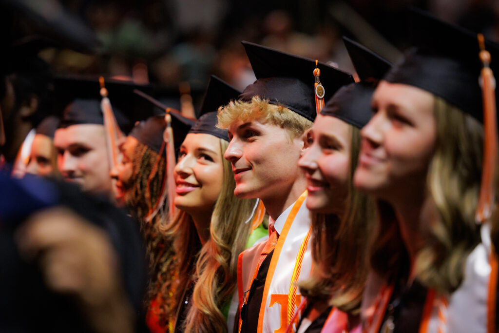 Graduates sing the alma mater during the College of Communications and Information (CCI) commencement ceremony inside Thompson-Boling Arena at Food City Center on May 16, 2024.