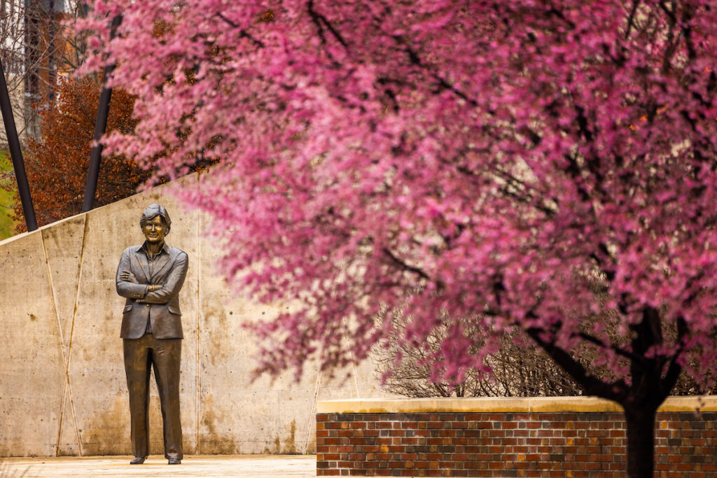 Pat Summitt statue at the Pat Summitt Plaza through the view of surrounding Eastern Redbud trees. Photo by Steven Bridges, University of Tennessee.