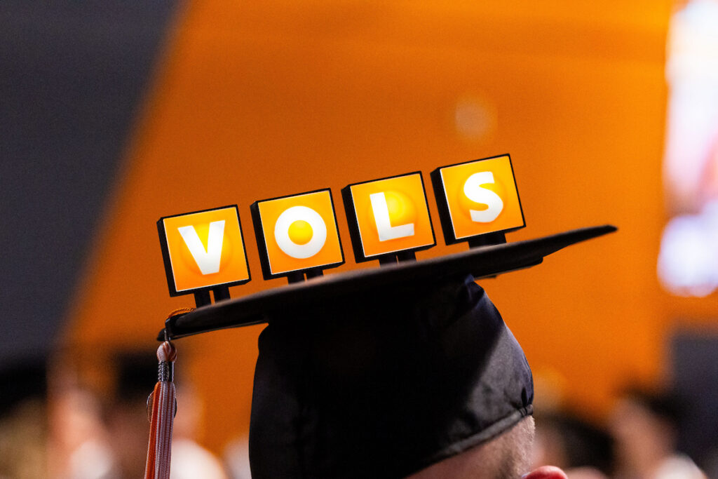 A graduate wears a mortarboard decorated with the word "VOLS" at the commencement ceremony. Photo by Steven Bridges, University of Tennessee