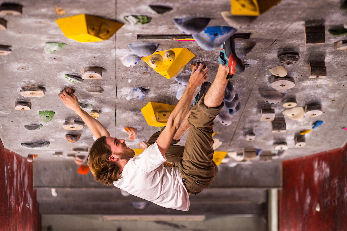 A student climbs upside down inside the boulder cave of the Climbing Wall “Vol Wall” in the Health, Physical Education, and Recreation Building (HPER)  on April 04, 2023. Photo by Steven Bridges/Steven Bridges/University of Tennessee.